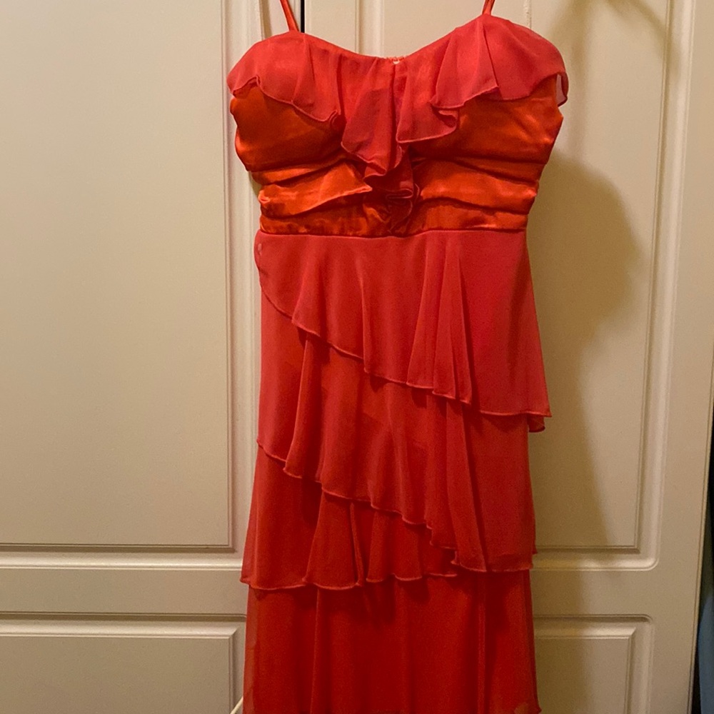 Coral spaghetti strap dress with layered flounce skirt.